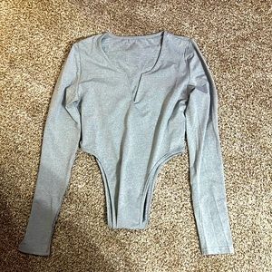 Grey long sleeve body suit with buttons at the bottom. Size medium.